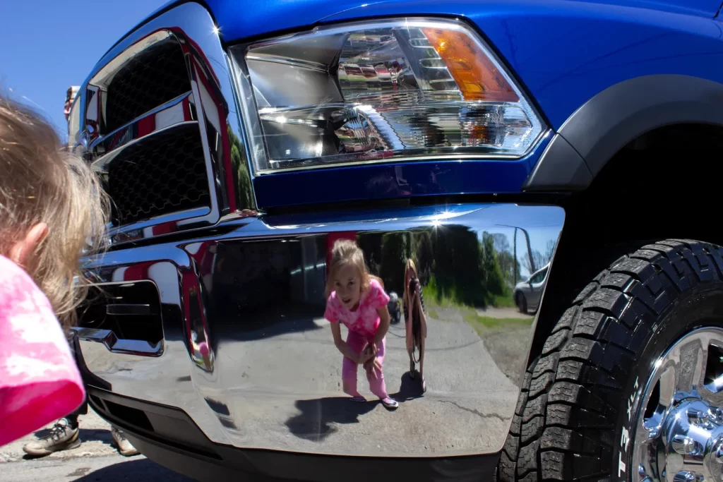 kid looking in truck after ceramic coating from detail shop